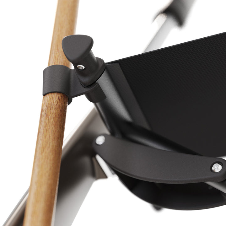 Close up of a walking cane holder attached to a walking frame