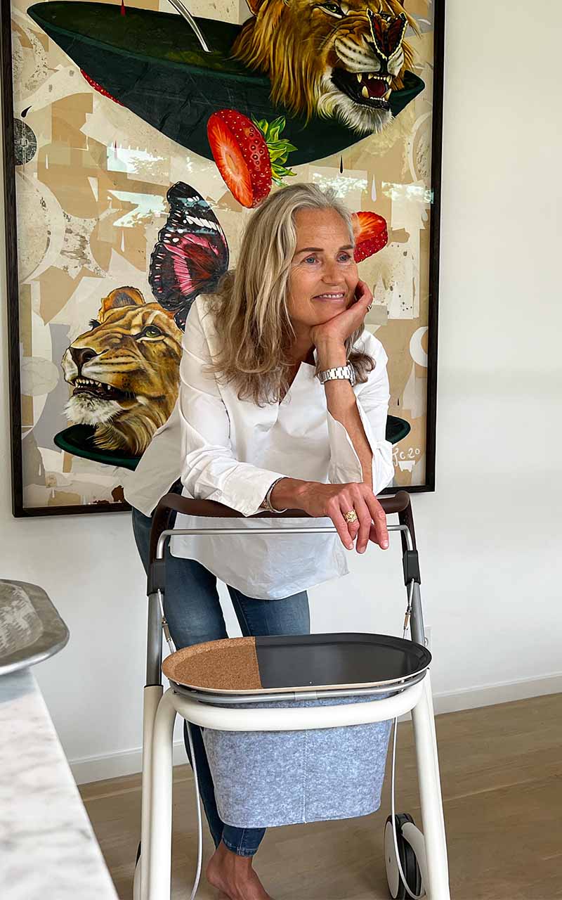 A woman supports herself inside her loungeroom with a byACRE indoor walker