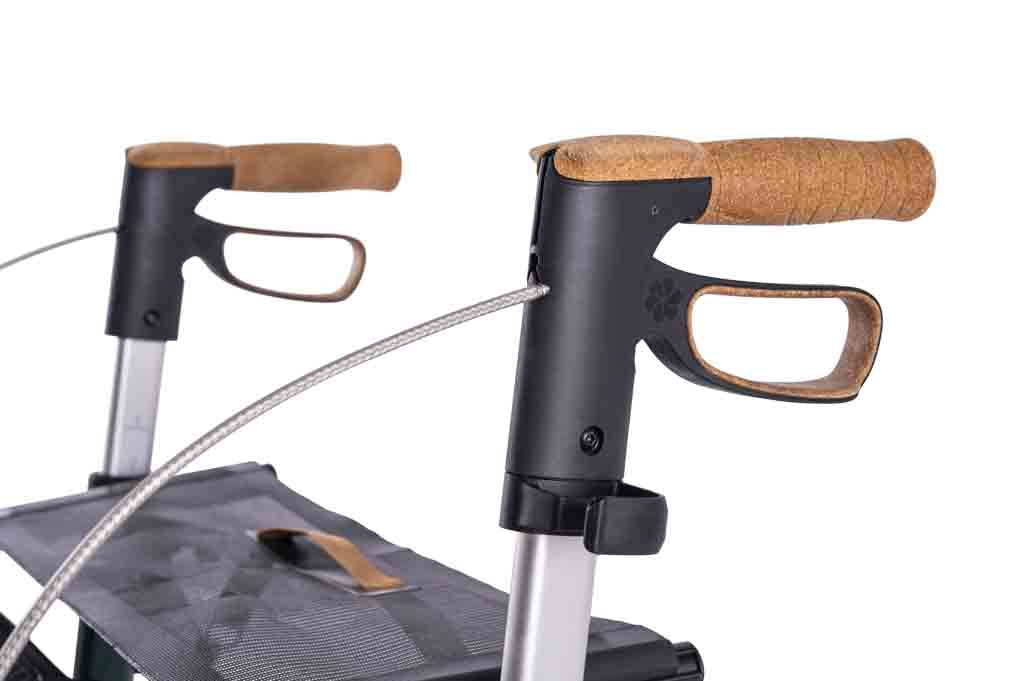 a close up of the handles on a carbon fibre Saljol rollator on a white background