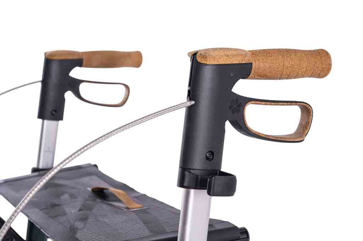 a close up of the handles on a carbon fibre Saljol rollator on a white background