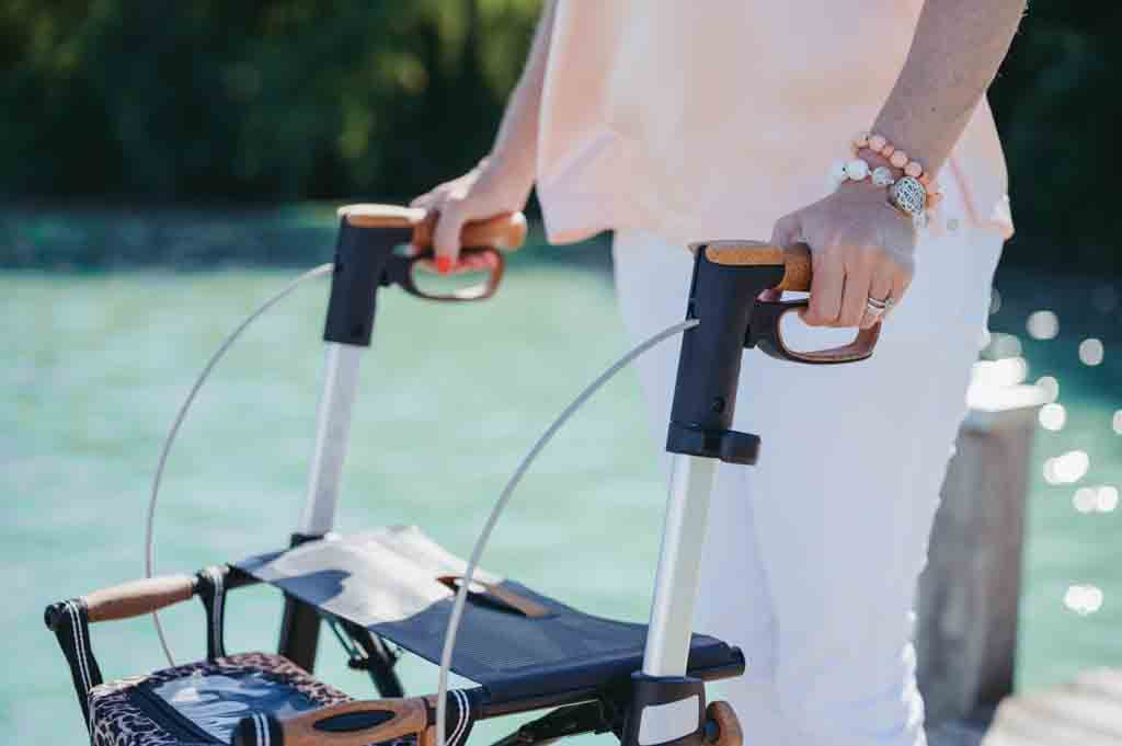 Close up of a woman holding the handles on the Saljol Carbon Fibre Walker 