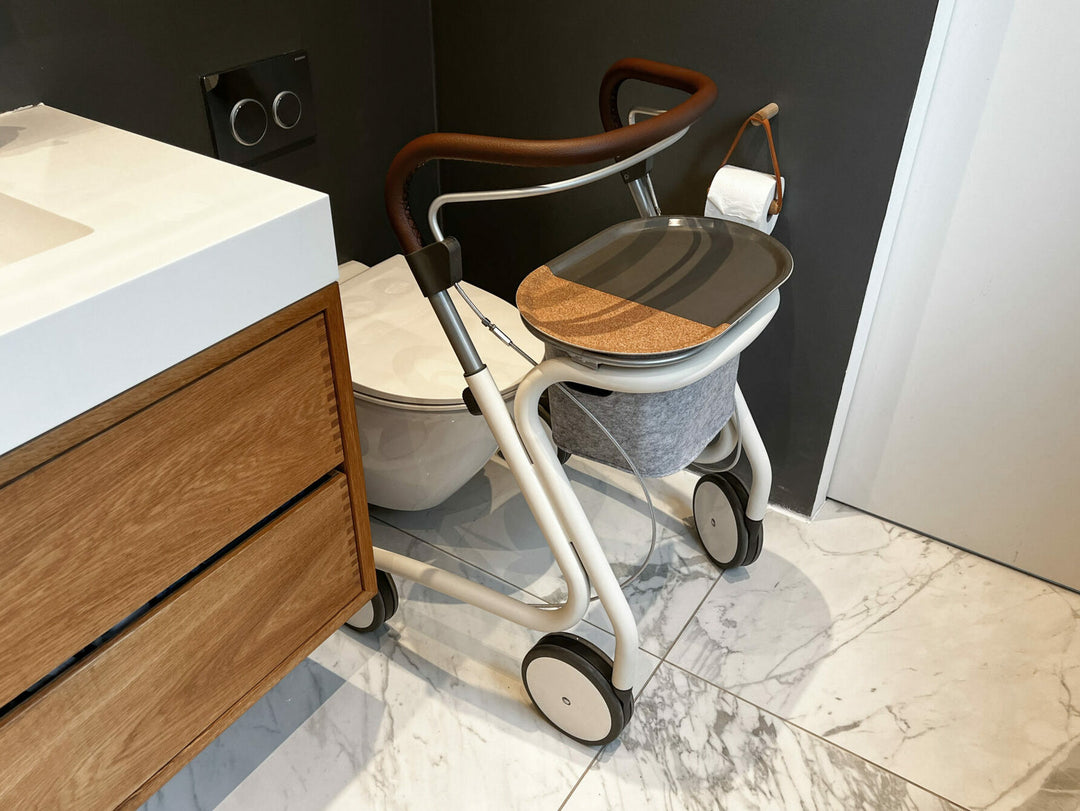The 'byACRE' indoor walker is shown next to a toilet in a modern bathroom