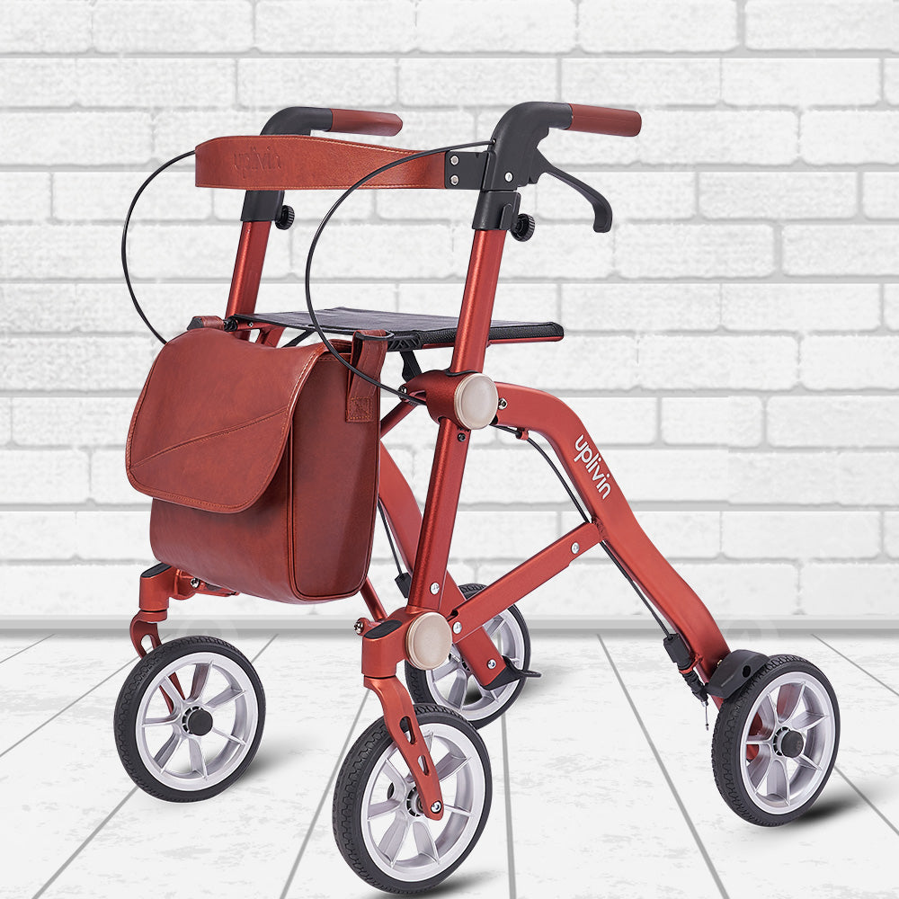 Orange 'Trive' rollator with a bag and backrest attached, on a white brick background.