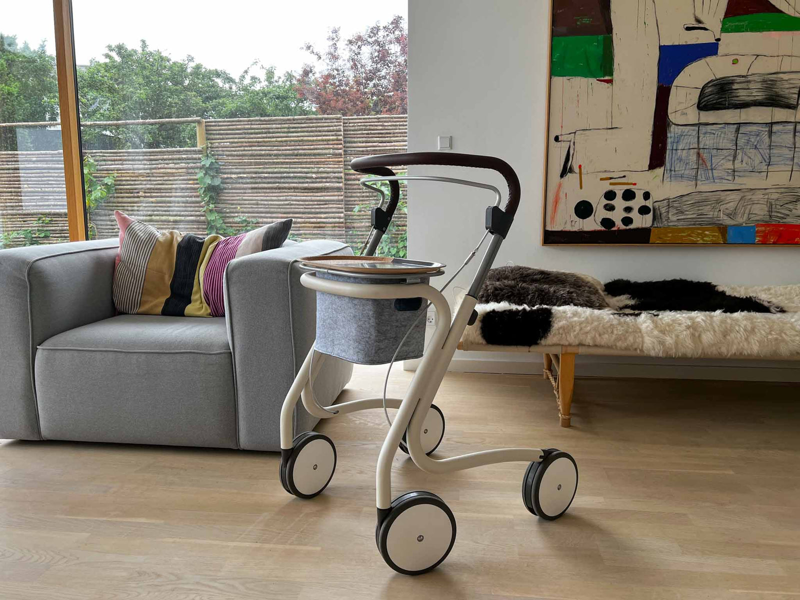 byAcre Scandinavian Butler indoor rollator walking frame in a modern loungeroom with a coach and artwork on the wall