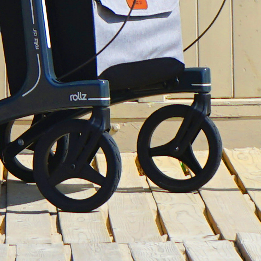 Close-up of the wheels on a rollz mobility aid on a wooden surface