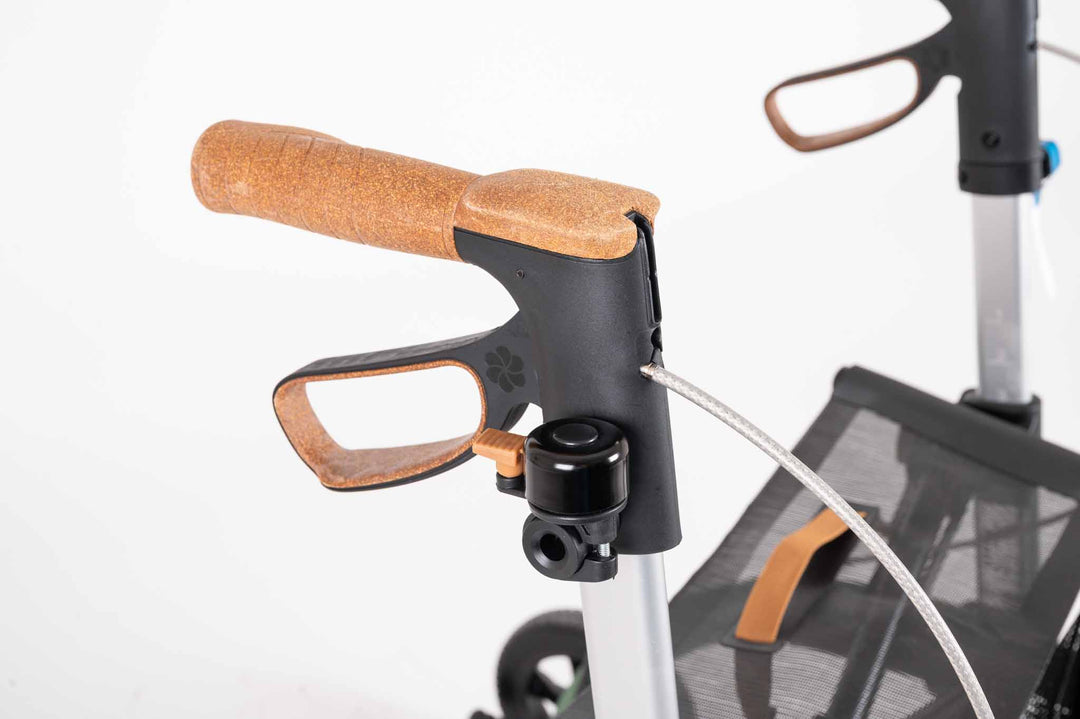 a close up of the the bell on a carbon fibre Saljol rollator on a white background