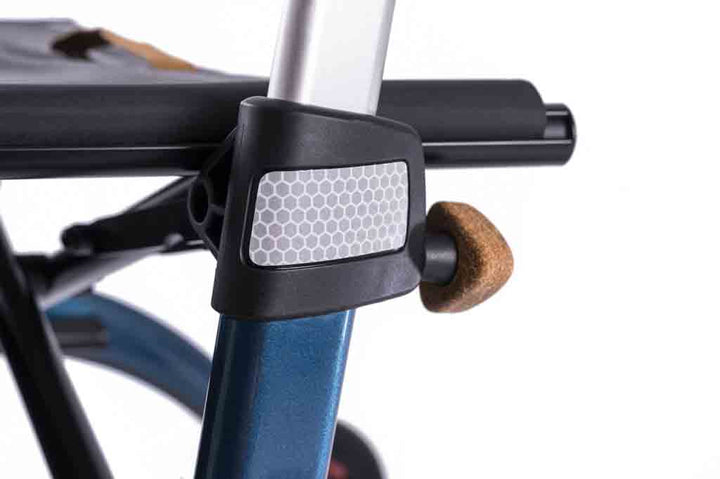 A close up of a reflector on a carbon fibre Saljol rollator on a white background